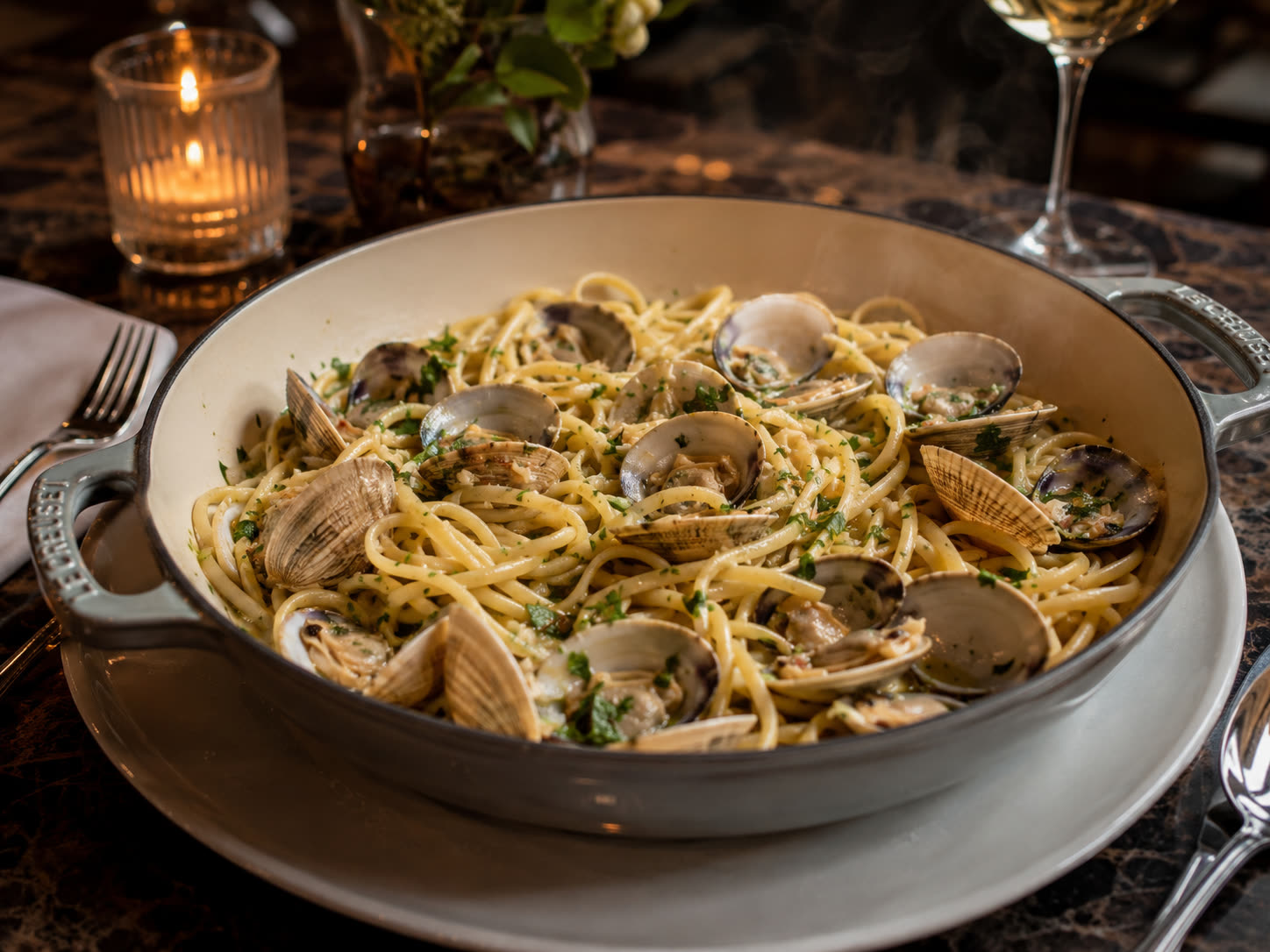 Linguini with clams served in a white pan