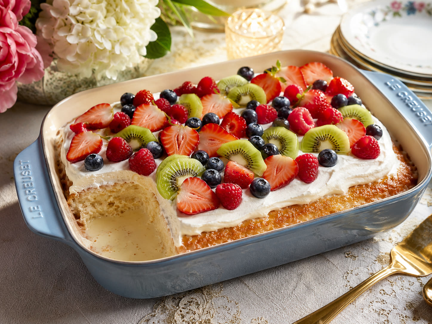 Tres leches dessert topped with fresh fruit